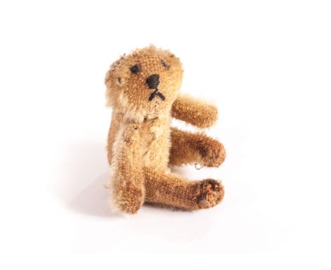 A Farnell ‘soldier’ Teddy Bear, circa 1918, with blonde mohair, restitched black eye, nose and mouth, remains of pipe-cleaner