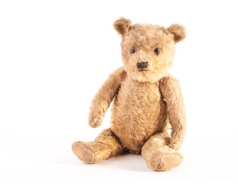 A Chiltern type Teddy Bear, 1930s, with golden mohair, clear and black glass eyes with remains of brown painted backs, black 