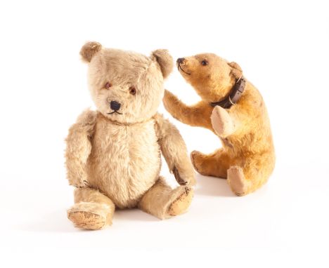 Two Chiltern Bears: a post-war Hugmee Teddy bear with pale golden mohair, orange and black glass eyes, black stitched nose, m