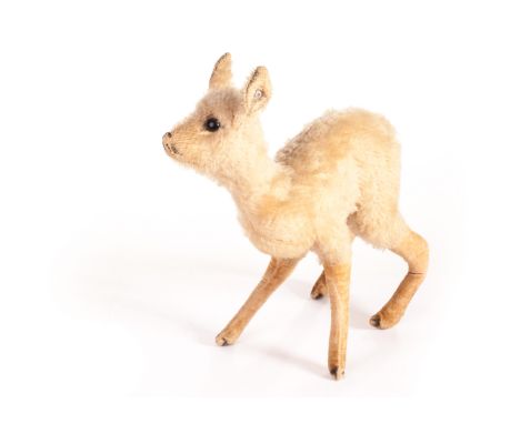 A pre-war Steiff fawn, with golden mohair, one black glass eyes, velvet lower legs and FF button in ear, 1930s - 9in (23cm) l