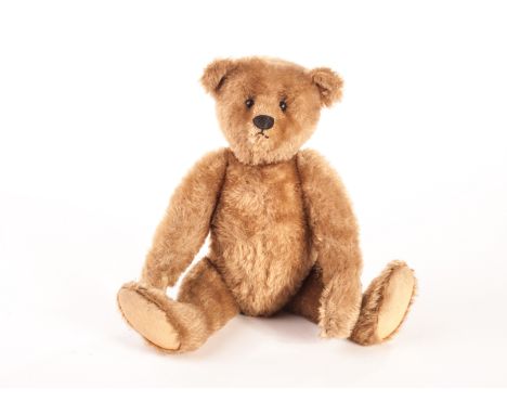 A fine and early Steiff Teddy Bear, circa 1909, with dark blonde mohair, black boot button eyes, pronounced clipped muzzle, b