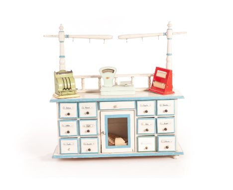A German child’s toy shop counter for the German market, early 20th century, painted white and blue with twelve drawers with 