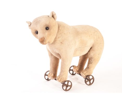 A very rare and early Steiff bear on wheels with rod jointed head, circa 1904, with white mohair, black boot button eyes, pro