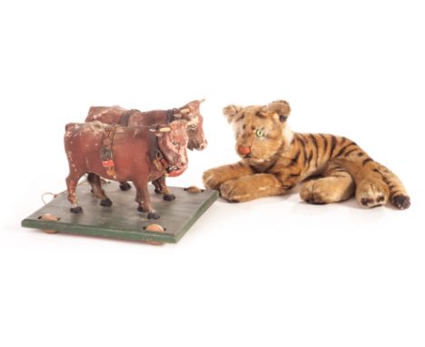 An interesting carved and painted wooden oxen team on wheeled platform, late 19th century, painted brown with leather and cop