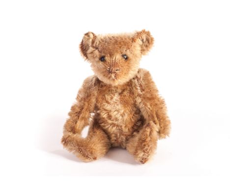 A small Steiff Teddy Bear, circa 1910, with dark blonde mohair, black boot button eyes, pronounced muzzle, swivel head, joint