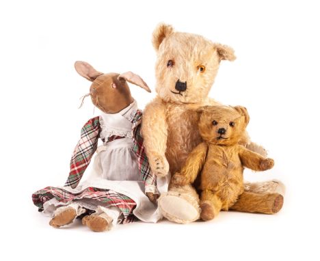 A Chiltern type Teddy Bear, 1930s, with golden mohair, orange and black glass eyes, black stitched nose, mouth and claws, swi