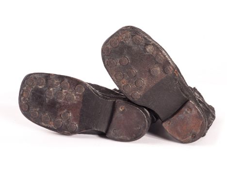 A rare pair of Steiff doll boots, circa 1910, black oil-cloth with leather soles and fifteen FF buttons in each sole - 4in (1