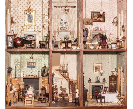 A Victorian Cupboard dolls’ house, 1850s, the mahogany cupboard with carved detail, keyhole with brass escutcheon, opening to