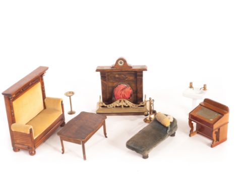 Dolls’ house furniture: comprising writing desk - 3 1/2in (9cm) high; oak settle; fireplace with mantel clock; chaise longue 