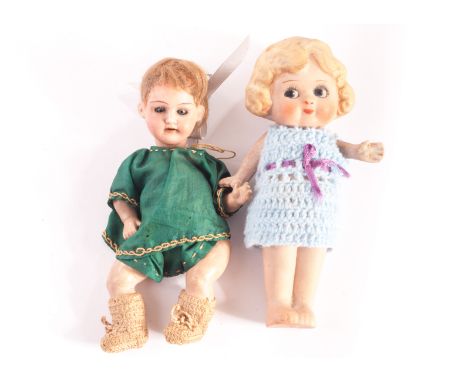 A German small bisque headed baby doll, with blue sleeping eyes, brown mohair wig, bent-limbed composition body and dark gree
