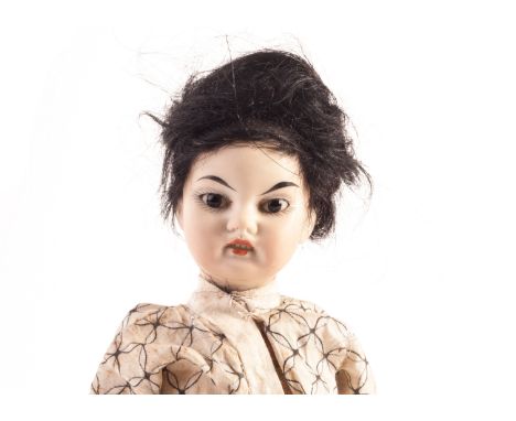 A German bisque headed Oriental child doll, with fixed dark slanting eyes, black mohair wig, straight limbed composition body