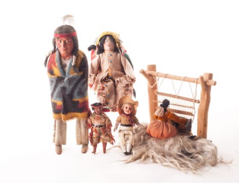 A Skookum Native American Indian Brave doll, 1930s, with painted moulded composition head, long hair wig, wooden body, hide c