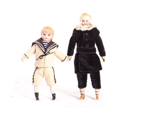 A bisque shoulder-head boy doll, with painted blonde hair and blue eyes, stuffed body, bisque lower limbs with painted boots 
