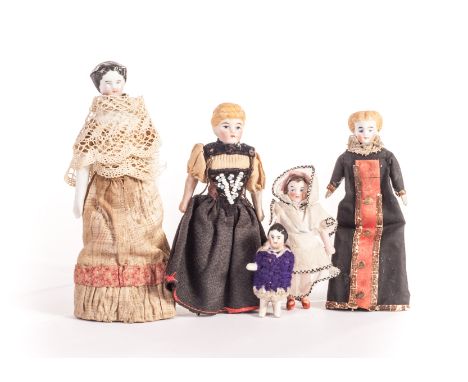 An all-bisque dolls’ house girl doll, with brown moulded bobbed hair - 3in (8cm) high; two bisque shoulder-head dolls’ house 