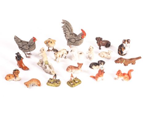 Miniature animals: including two bisque dogs in hats; a metal dog in a boot; two tiny composition groups of chicken with chic