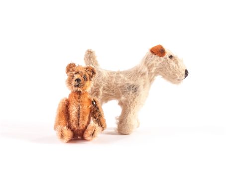 A Schuco Teddy Bear compact, 1920s, with peach short mohair, metal bead eyes, metal-framed jointed body, removable head and b