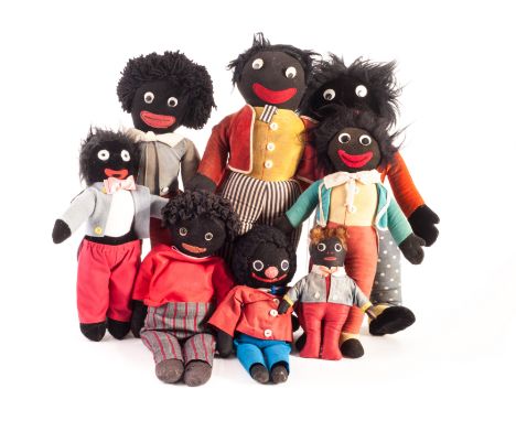 British Golliwogs: a 1920s flat cloth Golly with fur hair, probably Chad Valley - 8in (20cm) high; two Merrythought with labe