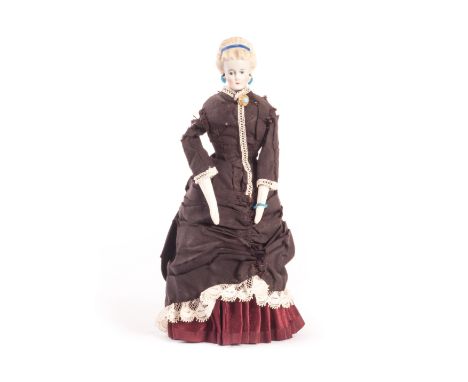 A German bisque shoulder-­­ head dolls’ house doll with elaborate moulded hair, with blue painted eyes, unusual pierced ears,