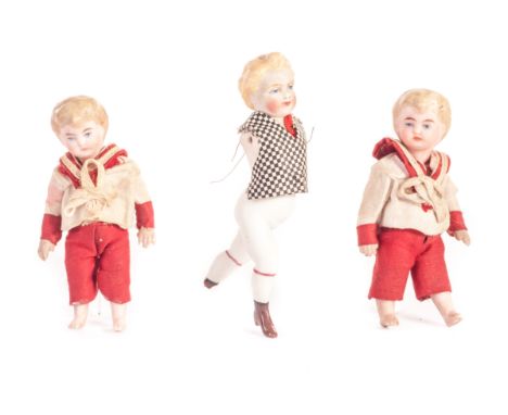 Two all-bisque dolls’ house boy twin dolls, five jointed with painted blonde hair and blue eyes and white and red sailor’s su