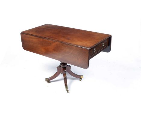 A late Georgian mahogany Pembroke tea table, the rectangular double flap top with fluted edge, above an unusual frieze drawer