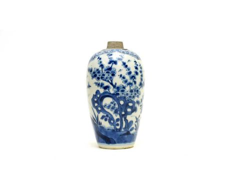 A Chinese small blue and white ovoid jar or caddy, Qianlong, decorated with two barbed panels of growing flowers. prunus and 