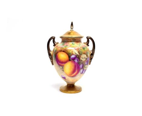 A Royal Worcester fruit painted vase and cover by Brain Leaman, with solid gilt cover and double gilt handles, painted with p