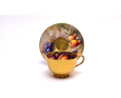 A Royal Worcester fruit painted teacup and saucer by Walter H Austin and William Ricketts, painted with peaches, strawberries