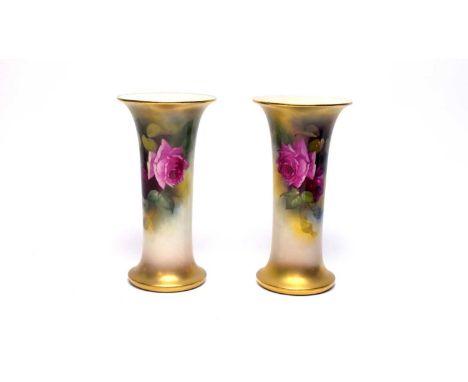 A near pair of Royal Worcester rose painted trumpet vases by Miss Mildred (Millie) Hunt, each with full blown pink and red ro