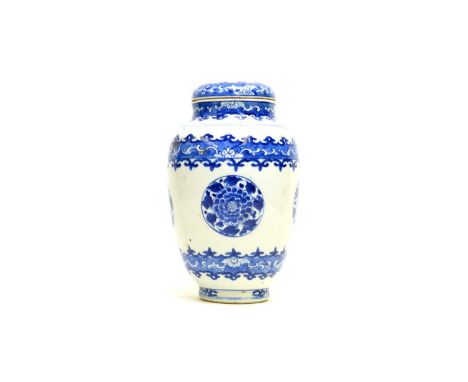 A Chinese blue and white jar and cover, probably kangxi, of slender ovoid form, decorated with roundels of flowers within for