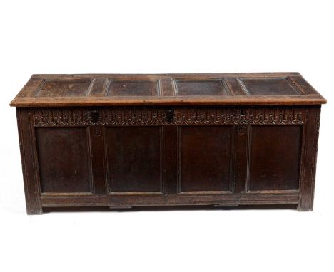 A late 17th Century oak coffer, with four panel hinged cover, above a barleycorn frieze, panel front and sides, raised on sti