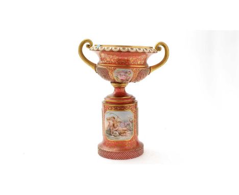 A Bohemian ruby overlay glass vase, with squared white glass medallions painted with pink rose bouquets, gilt scrolling folia