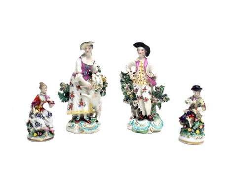 A pair of small Derby figures of a shepherd and shepherdess, late18th century, with bocage supports and scroll moulded bases,