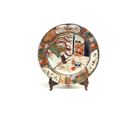 A large Japanese Imari shallow basin or charger,  Meiji period, well decorated with an interior scene with bijin looking on a