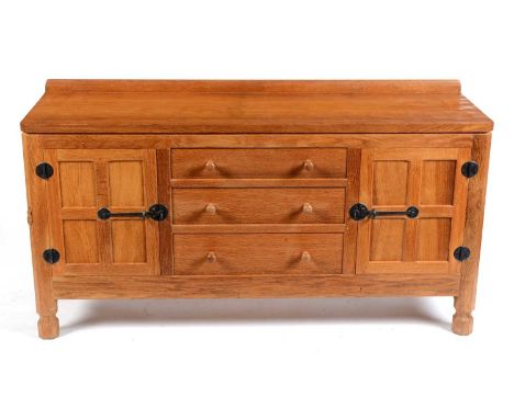 Robert 'Mouseman' Thompson of Kilburn: an oak sideboard, with raised stub gallery back and adzed honeycomb top, over a centra