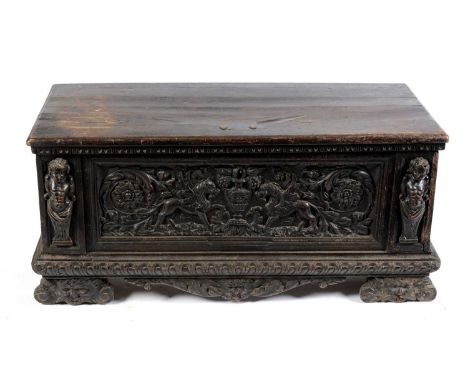 An Italian walnut cassone, probably 17th Century, the hinged cover opening to reveal a spacious interior with candle box, ove