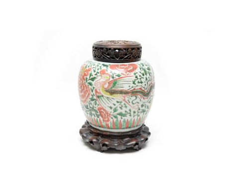 A Chinese Wucai ginger jar. Kangxi, decorated in iron-red, green and yellow with phoenix and chrysanthemums on a foliate scro
