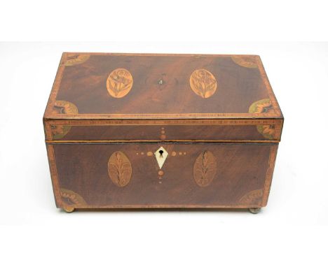 An early 19th Century inlaid mahogany tea caddy, with harewood and boxwood stringing, decorated throughout with flower and le