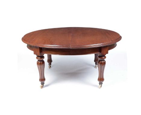 A Victorian mahogany oval extending dining table, the top with moulded edge opening to receive two additional leaves, raised 