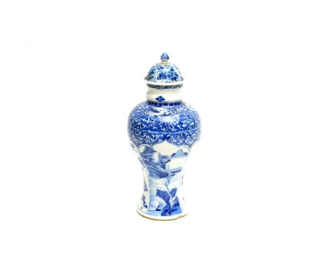 A Chinese blue and white baluster vase and cover, probably Kangxi, decorated with alternate panels of antiques and landscapes