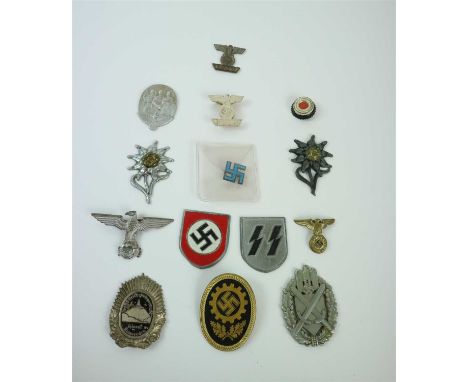 A group of German Third Reich badges and insignia including reproductions including pair of SS pith helmet shields; a German 