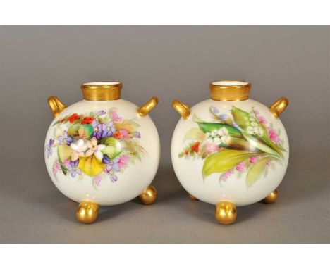 A pair of Royal Worcester tri-footed vases dated 1880, of globular form with small twin gilt handles and gilded ball feet and