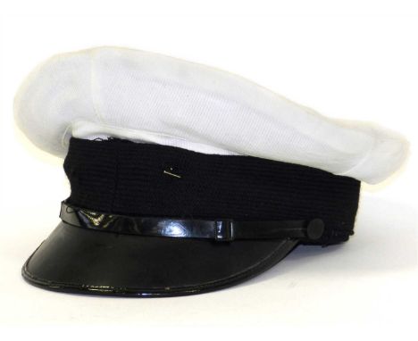 A British Royal Navy Officer’s white top cap constructed of dark blue wool with a pull-over white cover, with ribbed black cl