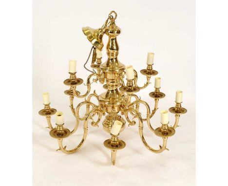 A large Dutch style brass two tier twelve light chandelier, the scrolling branches centred with a tapering baluster stem, 85 