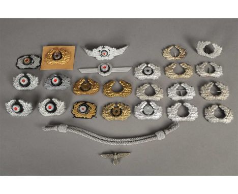 A mixed collection of German Third Reich visor cap insignia - predomiantly wreaths and cockades, together with gold and silve