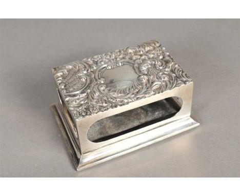 A silver mounted match box holder, James Deakin &amp; Sons, Chester 1900, of rectangular form with embossed scrolling decorat