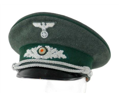 A Third Reich National Forestry Officer’s visor cap constructed of a dark green wool with a traditional high peak set crown a
