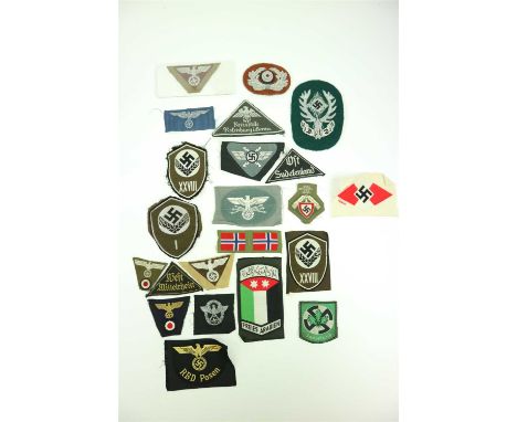 A group of German Third Reich cloth insignia including a Hiter Jugend sport shirt sleeve diamond for the BDM, Bevo type weave
