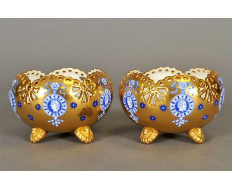 A pair of Coalport tri-footed bon bon dishes late 19th century, the circular bowls with pierced floral decoration to the uppe