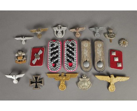 An assorted collection of insignia, predominantly German Third Reich - including cap eagles, police gorget eagle with luminou