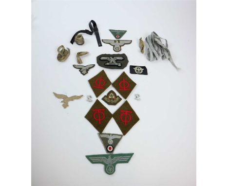 A collection of WW2 cloth insignia and patches comprising an Italian Fascist eagle cut away from uniform and the remainder al
